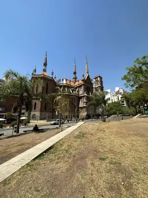 an old building with a grass field in front of it at Departamento premium, la mejor zona de Nueva Córdoba in Cordoba