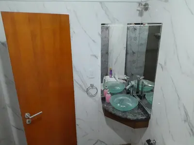 a bathroom with a sink and a mirror at Chalet El Buho in Villa General Belgrano