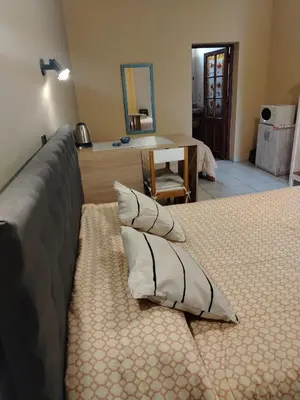 a bedroom with a bed with two pillows on it at Departamentos Centro in Villa Dolores