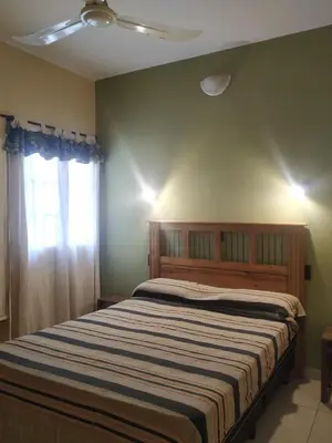 a bedroom with a bed and a window at Departamentos Centro in Villa Dolores