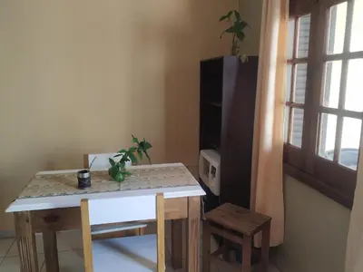 a table and chairs in a room with a window at Departamentos Centro in Villa Dolores