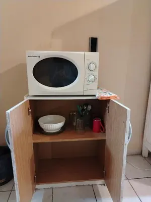 a microwave oven sitting on top of a shelf at Departamentos Centro in Villa Dolores