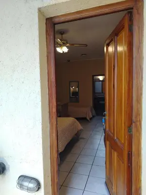 a door leading into a room with a bedroom at Departamentos Centro in Villa Dolores