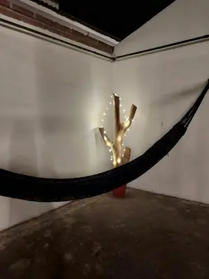 a hammock in a room with a tree on it at MAILY Guest House in Alta Gracia