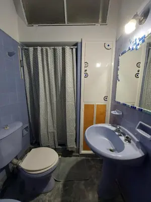 a bathroom with a toilet and a sink at MAILY Guest House in Alta Gracia