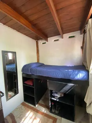 a small room with a blue bed in the corner at Casa Sol y Luna in Villa General Belgrano