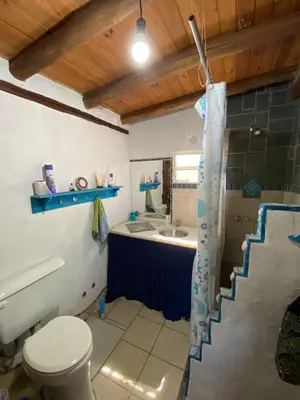 a bathroom with a toilet and a sink at Casa Sol y Luna in Villa General Belgrano