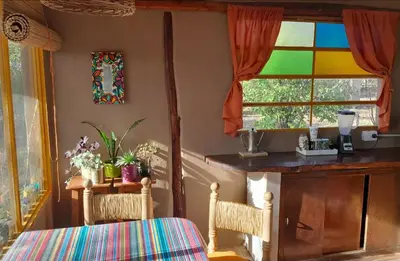 a dining room with a table and a stained glass window at Casa Sol y Luna in Villa General Belgrano