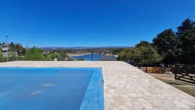 a blue swimming pool on the roof of a house at Casa del Lago in Potrero de Garay