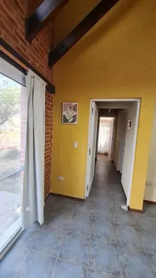 a hallway in a building with a yellow wall and a door at Casa del Lago in Potrero de Garay
