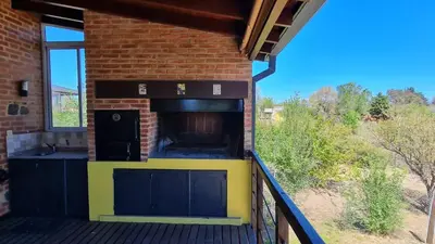 a brick building with a oven on a balcony at Casa del Lago in Potrero de Garay