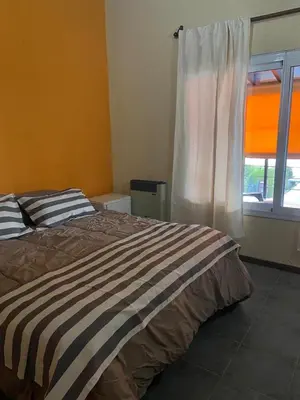 a bedroom with a bed and a window at Casa del Lago in Potrero de Garay