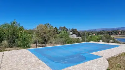 a large blue swimming pool in a backyard at Casa del Lago in Potrero de Garay