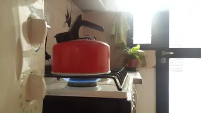 a red tea kettle sitting on top of a stove at Departamento Córdoba in Cordoba