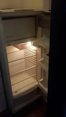 an empty refrigerator with its door open in a kitchen at Departamento Córdoba in Cordoba