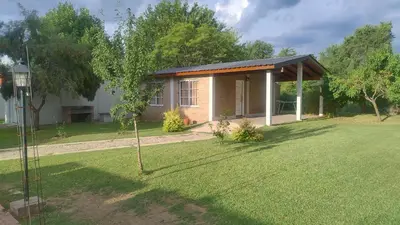 a small house in a yard with a tree at Cabaña el Torreon in San Ignacio