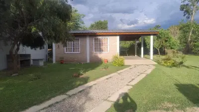 a small brick house with a grass yard at Cabaña el Torreon in San Ignacio