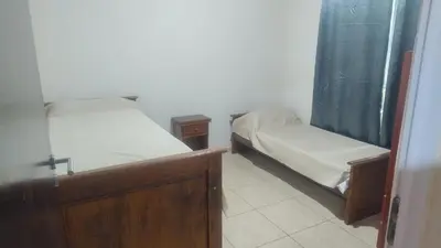 two twin beds in a room with a window at Cabaña el Torreon in San Ignacio