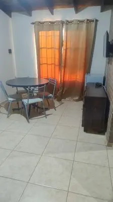 a dining room with a table and chairs and a window at Cabaña el Torreon in San Ignacio