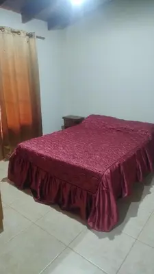 a bedroom with a bed with a purple bedspread at Cabaña el Torreon in San Ignacio
