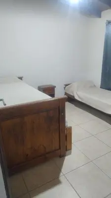 a bedroom with two beds and a tiled floor at Cabaña el Torreon in San Ignacio