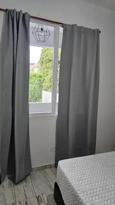 a bedroom with a bed and a window at RaGi dpto 4 in Cordoba