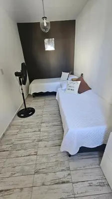 a room with two beds and a lamp in it at RaGi dpto 4 in Cordoba
