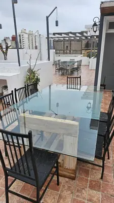 a glass table and chairs on a roof at RaGi dpto 4 in Cordoba
