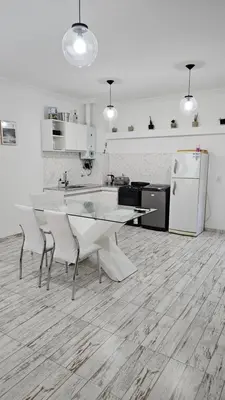 a kitchen with a table and chairs and a refrigerator at RaGi dpto 4 in Cordoba