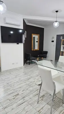 a living room with a glass table and chairs at RaGi dpto 4 in Cordoba