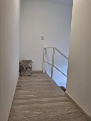 a hallway with a wooden floor and a metal railing at Gran Duplex Paseo Quattro 22 (centrico) - Cochera + Pileta in Villa Carlos Paz