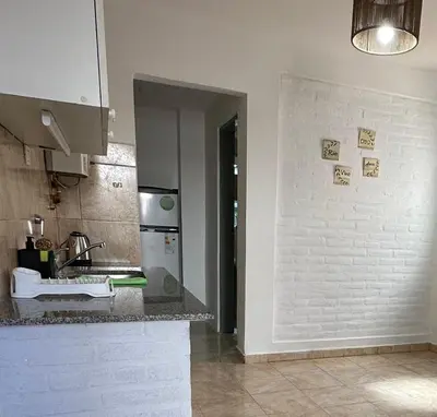 a kitchen with a sink and a counter top at CONFORTABLE Dpto. Pasaje Tucumán in Alta Gracia