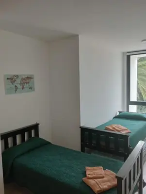 a bedroom with two beds and a window at Gran Duplex Paseo Quattro 21 (centrico) - Cochera + Pileta in Villa Carlos Paz