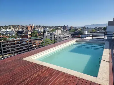 a swimming pool on the roof of a building at Gran Duplex Paseo Quattro 21 (centrico) - Cochera + Pileta in Villa Carlos Paz