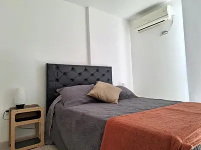 a bedroom with a bed with a pillow on it at Gran Duplex Paseo Quattro 21 (centrico) - Cochera + Pileta in Villa Carlos Paz