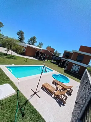 a pool with a swing and a frisbee at Complejo Bru-Mar in Los Olivares