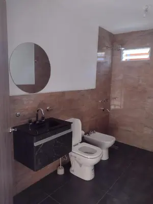 a bathroom with a sink and a toilet and a mirror at Complejo Bru-Mar in Los Olivares