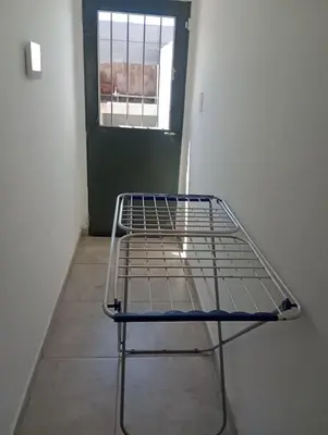 a metal bed in a room with a window at Complejo Bru-Mar in Los Olivares