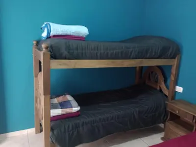 two bunk beds in a room with a blue wall at Complejo Bru-Mar in Los Olivares