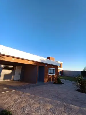 a house with a driveway in front of it at Complejo Bru-Mar in Los Olivares