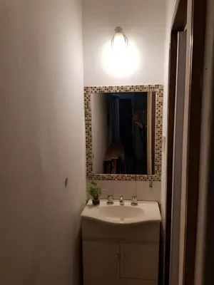 a bathroom with a sink and a mirror at Las Lavandas Tranquilidad cerca de todo in Mina Clavero