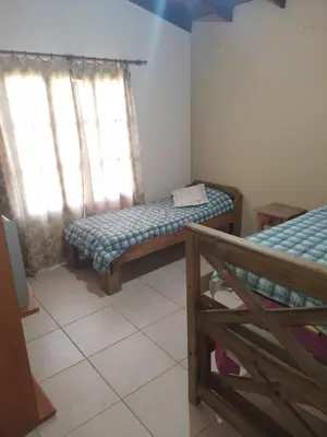 a small room with two beds and a window at Cabaña Corcovado in El Parador