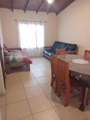 a living room with a table and chairs and a couch at Cabaña Corcovado in El Parador