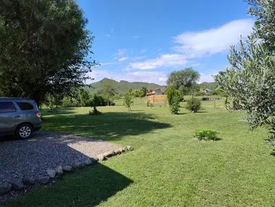a car parked in a yard with a grass field at Cabaña Corcovado in El Parador