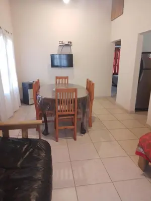 a kitchen and dining room with a table and chairs at Cabaña Corcovado in El Parador