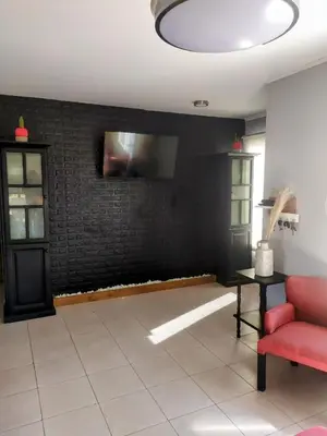 a living room with a red couch and a black wall at Amanecer serrano in Tanti