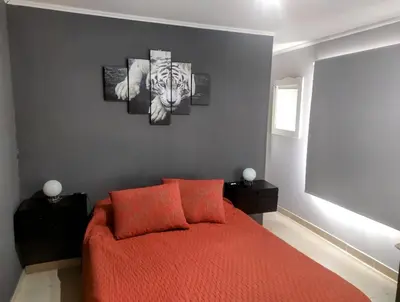 a bedroom with a bed and a painting of a zebra at Amanecer serrano in Tanti