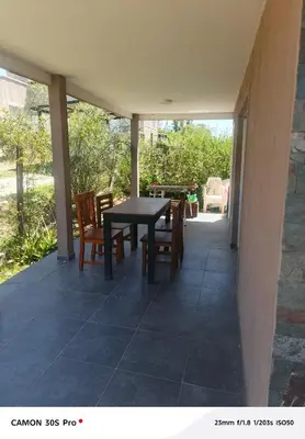 a patio with a table and chairs on a house at Amanecer serrano in Tanti