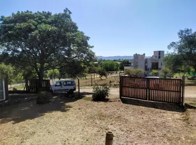 a white van parked in a yard with a fence at Amanecer serrano in Tanti