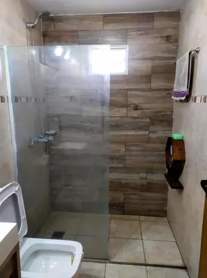 a bathroom with a shower with a toilet and a sink at Amanecer serrano in Tanti
